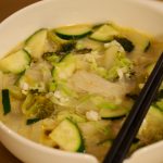 Eine Glasnudelsuppe in einer Schüssel über der zwei Essstäbchen gelegt wurden