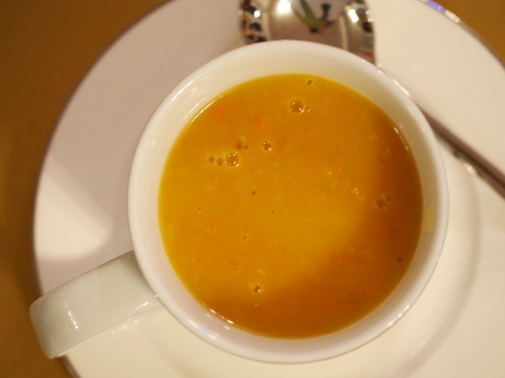 Eine Jumbotasse gefüllt mit einer Karotten-Kartoffelsuppe