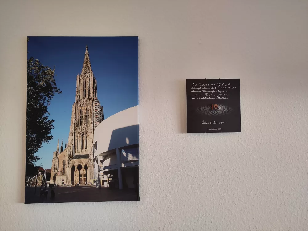 Der Stein hängt nun dank der Telleraufhängung neben einem Bild des Ulmer Münsters an der Wand.