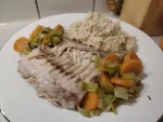 Ein Stück des Fischfilets zusammen mit dem Lauch-Karotten Gemüse und etwas Meerrettich-Reis auf einem Teller